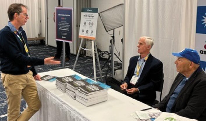 Harvey Silver and Jay McTighe autograph their book, Teaching for Deeper Learning at ASCD's Annual Conference March 18, 2022 in Chicago